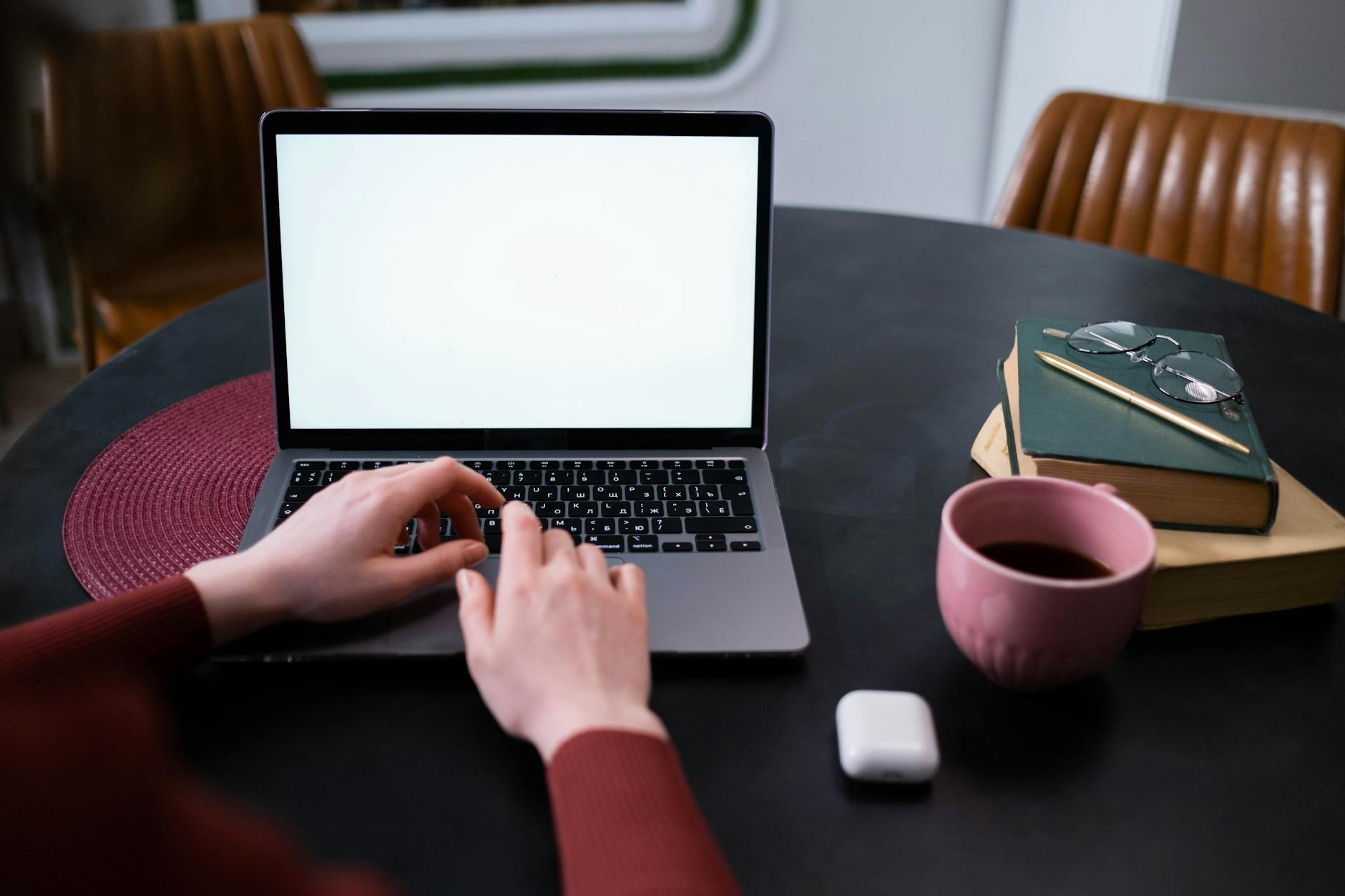 a woman using a laptop with a blank screen