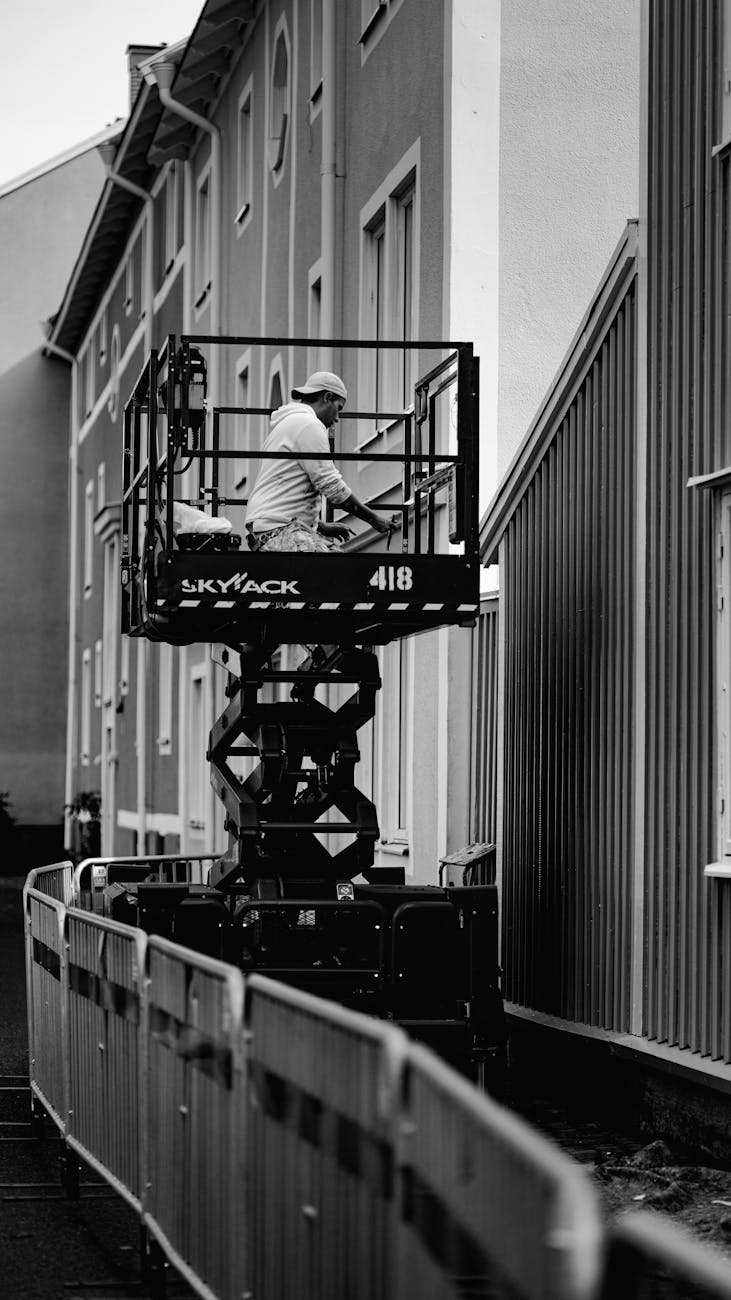 man working on lift in black and white